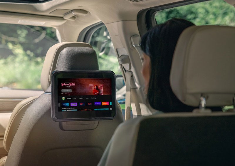 A person is seated in a 2023 Lincoln Nautilus SUV viewing an available entertainment screen. | Wallace Lincoln in Fort Pierce FL